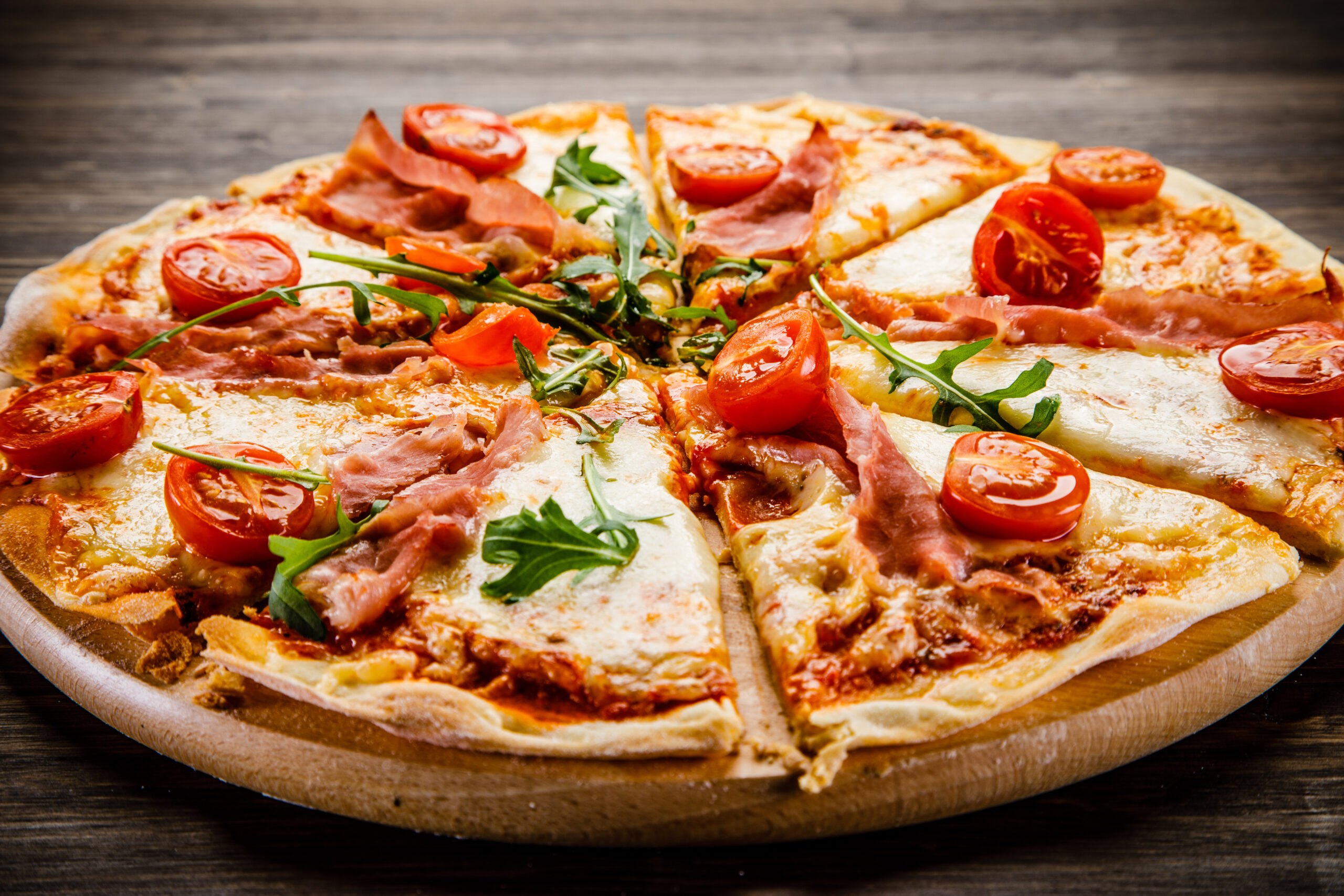 Pizza margherita with black olives on wooden background
